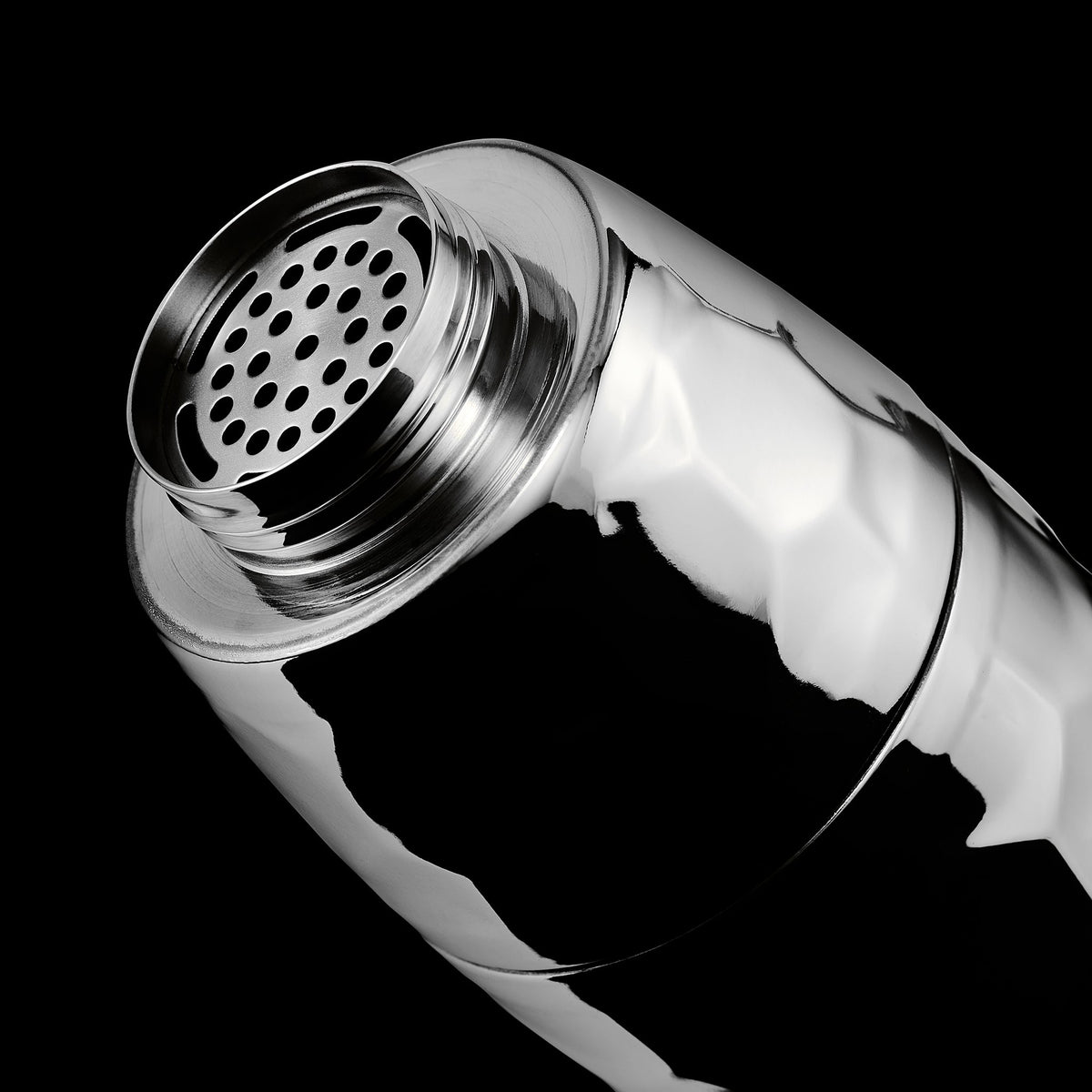 Chrome hexclad cocktail shaker open top on a black background